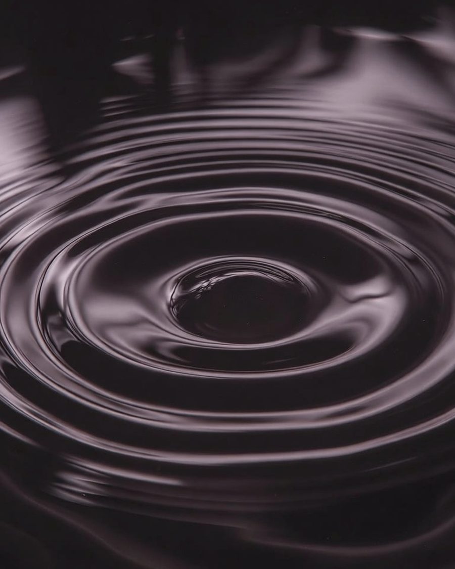 Konzentrische Ringe auf dunklem Wasser